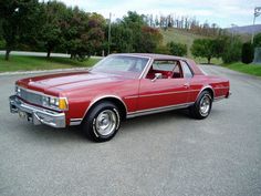 a red car is parked in a parking lot