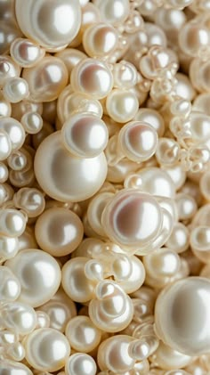 white pearls are arranged together in a pile