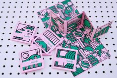 several pieces of pink and green stickers on a white surface with holes in it