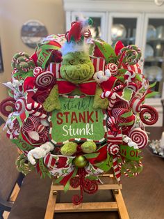 a christmas wreath with an elf's head and candy canes on it that says stink stanki stuff