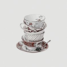 a stack of tea cups and saucers sitting on top of each other in front of a white background