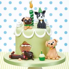 a birthday cake decorated with dogs and candles