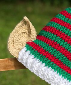 a crocheted hat with a wooden stick sticking out of it