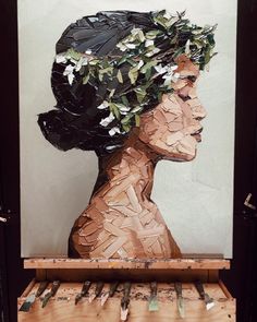 a woman's head made out of pieces of paper