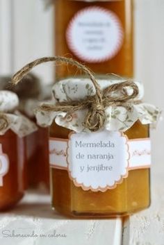 three jars filled with honey sitting on top of a table