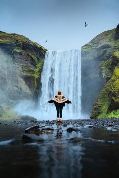 A woman at Skogafoss in Iceland. Linked to a travel guide on How to Visit Skogafoss in Iceland - Full Iceland Road Trip Itinerary and Planning Guide Included.