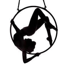 a woman is doing aerial acrobatics in a hoop on a white background