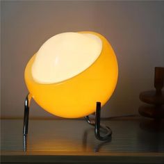 a yellow lamp sitting on top of a table