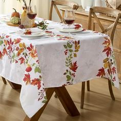 a dining room table covered in fall leaves