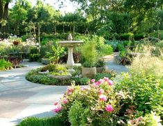 a garden with lots of flowers and plants around it