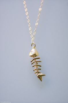 "M A T E R I A L S: - 14k gold filled chain and findings. - Gold plated skeleton fish pendant. - Pendant approximate measurements: 27.4mm x 8.2mm Please select your desired necklace length at the dropdown menu. Model wears a 18\" length. Don't see a length that you like? Just let me know upon check out. O P T I O N S: ♥ See more sterling silver and gold filled pieces here ♥ https://etsy.me/2PqZ7DY C A R E: - Please take special care by keeping all jewelry pieces from any type of liquid, perfume, Fishbone Necklace, Gifts For Fisherman, Fish Bone Necklace, Skeleton Fish, Skeleton Necklace, Aesthetic Necklace, Fish Skeleton, Fantasy Earrings, Necklace Aesthetic