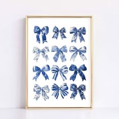 a blue and white bow print in a gold frame