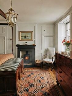 a bed room with a neatly made bed and a fireplace