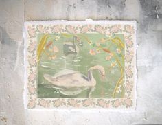 a painting on a wall with swans swimming in the water and flowers around it's edges