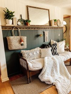 a living room filled with lots of furniture next to a wall covered in pictures and plants