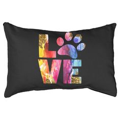 a black pillow with the words love and a dog's paw painted on it