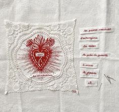 a piece of white paper with red ink on it and some type of doily