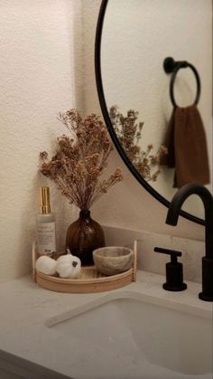 a bathroom sink with a mirror above it and soap dispenser next to it