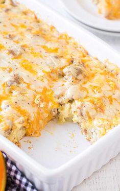 a casserole dish with meat and cheese on it next to an orange slice