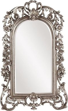 an ornate silver framed mirror on a white background with leaves and scrolls around it,