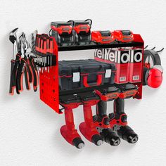 a red tool rack with tools hanging from it