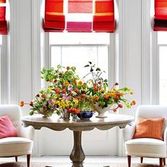 two chairs and a table with flowers on it