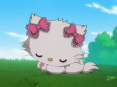 a white cat with pink bows sitting in the grass