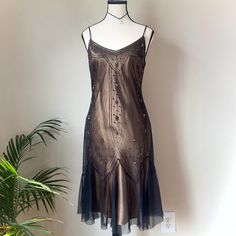 The most stunning vintage beaded drop waist bronze/gold dress with brown lining & sheer black mesh overlay. Tagged a size 7/8 Such a gorgeous dress! Features intricate beading details, slightly flared ruffle fairy style hem, & zipper closure on side. Great preloved condition aside from a few missing beads/loose threads, as well as two small spots on top inner lining (not visible while wearing.) The clasp at the top of the zipper is also kind of wonky but the zipper itself works perfectly.  Brand Intricate Beading, Gold And Black Dress, Fairy Style, Flapper Style, Fairy Fashion, Womens Vintage Dresses, Bronze Gold, Gothic Dress, Mesh Overlay