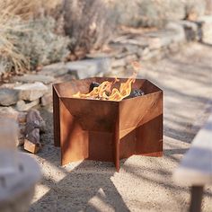 a fire pit sitting in the middle of a dirt field