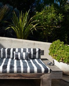 A black and white striped Bold Stripe Performance Fabric Slate cushion from the Eskayel Stripes Collection, made of luxury performance fabric, on a wooden bench Breakfast Rooms, Striped Sofa, Nautical Colors, Flame Test, Back Deck, Sunbrella Fabric, Bold Stripes, Breakfast Room, Performance Fabric