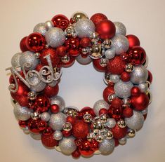 a red and silver christmas ornament wreath