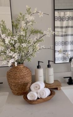 a bathroom with white flowers and towels on the counter