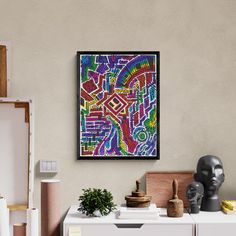 a colorful painting hangs on the wall above a white dresser