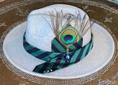 Upstyled evil eye hat with peacock feather, vintage silk tie and herkimer diamonds. 65% polyester and 35% wool. Size 22.5 or fit size between 7 1/8 and 7 1/4. There is a drawstring to tighten fit. See size chart in photos. Feathers For Hats, Upcycle Ideas, Painted Hats, Hat Styles, Blue Fluorite, Fashion Closet, Male Character, Cowgirl Hats, Hat Ideas