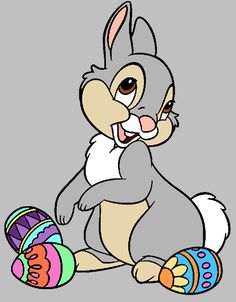 a cartoon bunny sitting next to some easter eggs