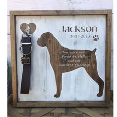 a wooden sign with a dog's name and leash hanging on the wall next to it