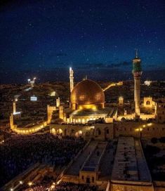 an aerial view of the old city at night, with lights shining on the buildings