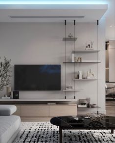 a modern living room with white walls and black accents on the wall, along with a large television