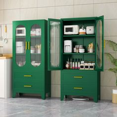 two green cupboards with glass doors in a kitchen