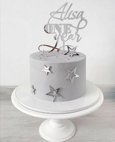 a white cake with silver stars on top