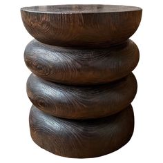 three wooden stools stacked on top of each other in the shape of an object