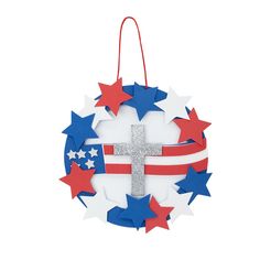 a patriotic wreath with a cross hanging from it