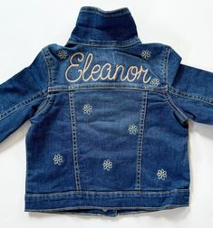 What's better than having a special jean jacket made to surprise your kiddo with their name on it! Please indicate the name you wish to have on the back of the jacket, along with some favorite colors so I can personalize the jacket for them.  the name and flowers can be done in any color they like.  *Due to the personalization of these jacket I cannot do returns. If you have an issue please contact me and I will be more than happy to try and resolve the problem! If you can't find a specific size Customizable Cute Denim Jacket, Fitted Denim Jacket With Custom Embroidery, Girls Jean Jacket, Charleston Wv, Jean Jacket For Girls, Fitted Denim Jacket, Love Jeans, Recycle Clothes, Personalized Embroidered