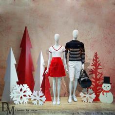 two mannequins dressed in red and white standing next to each other