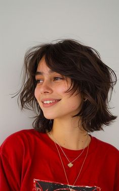 Woman with a short wolf cut featuring choppy layers and curtain bangs for a trendy, textured look. Wolf Haircut For Short Hair, Wavy Wolf Cut Short Hair, Wolf Cut Hair Short Mullet Style Women, Choppy Layers For Short Hair, Short Curtain Bangs With Layers, Wolf Cut Thick Hair, Short Wavy Wolf Cut, Short Hair Layered Cut, Short Wolf Haircuts