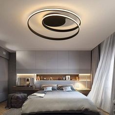 a bed room with a neatly made bed and a round light hanging from the ceiling