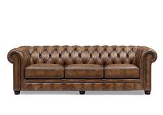 a brown leather couch sitting on top of a white floor