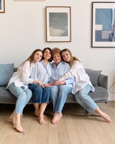 three women sitting on a couch with their arms around each other