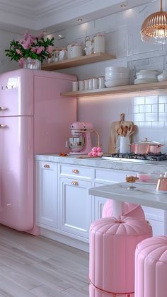 a pink refrigerator in a white kitchen with lots of counter space and decorations on the shelves