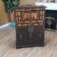 an old wooden chest sitting on top of a hard wood floor